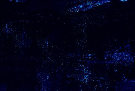 The metal texture of the background painted in black paint with smudges, scratches and splashes of classic blue sparklesの写真素材