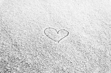 Heart painted on snow and there are and Many grains of white snow and snowflakes, February 14の写真素材