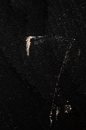 black painted metal background with scratches, texture, fine shine of metal, scratches and splashes of gold sparklesの写真素材