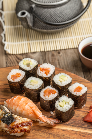 Rolls with avocado and tuna and assorted sushi on wooden plateの写真素材