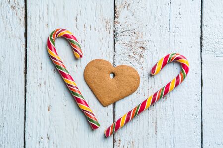 Christmas backgrounds. Christmas decor on wooden background with cookies and cane. View from aboveの写真素材