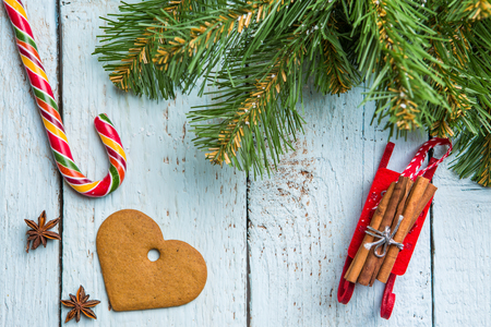 Christmas tree brunches, cookie and lollipop on white wooden boards. Chistmas background.の写真素材