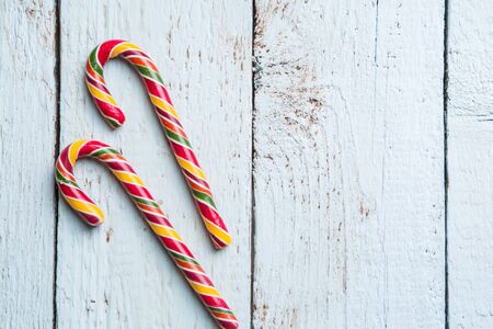 Christmas decor on white wooden background with two cane. Christmas backgrounds. View from aboveの写真素材