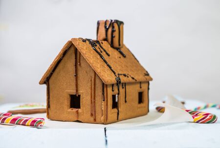Homemade gingerbread house whit caramel on white backgroundの写真素材