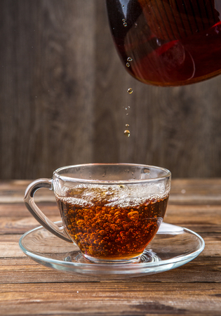 Herbal tea poured from kettleの写真素材