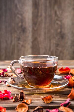 Teacup on table with petalsの写真素材