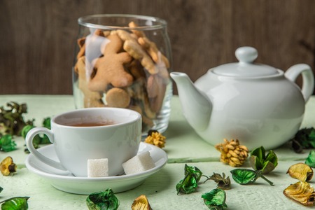 White teapot and cup with teaの写真素材