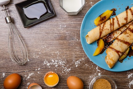 Pancakes with peaches, topped chocolateの写真素材