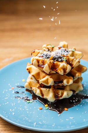 Homemade waffles sprinkles chocolate and coconutの写真素材