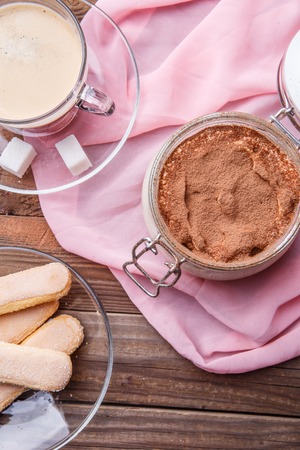 Tiramisu, coffee , savoiardi on pink tissueの写真素材