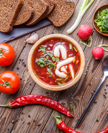 Beet soup in wooden plate with vegetablesの写真素材