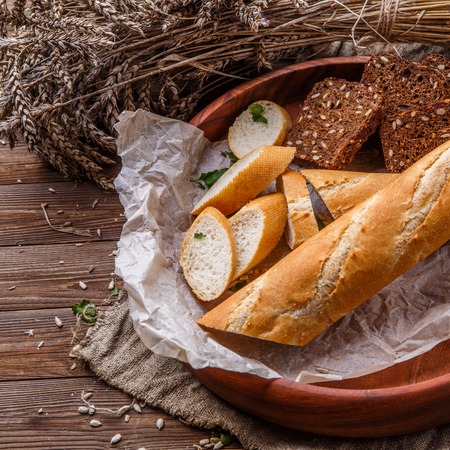 Fresh bread in wooden dishの写真素材