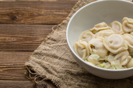 Meat dumplings - russian pelmeni, ravioli with meat on a white plateの写真素材