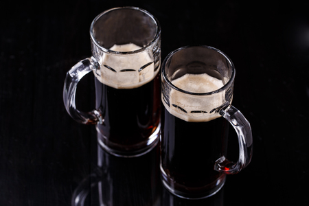 Beer on empty black tableの写真素材