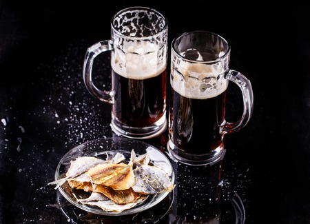 Mugs of beer with fish