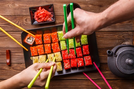 Sushi Set rolls with soy sauce served on black plateの写真素材