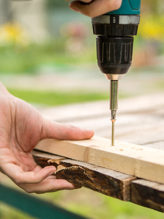Man working with an electric screwdriverの写真素材