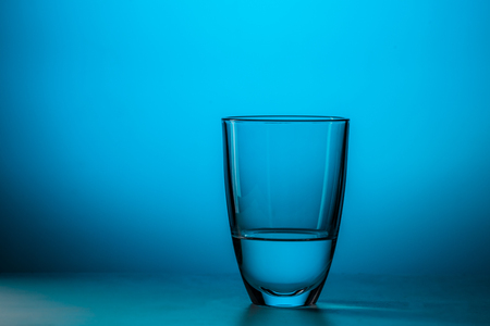 Full glass on blue backgroundの写真素材