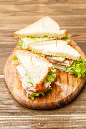 Sandwiches with toothpicks and vegetablesの写真素材