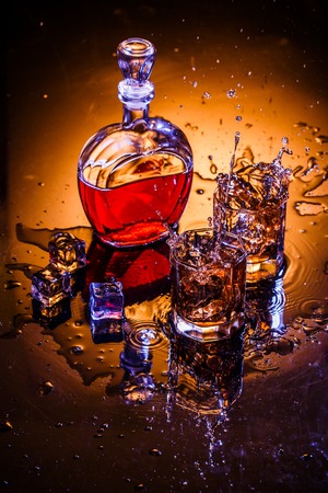 Decanter and two glasses with whisky and iceの写真素材