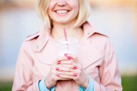Portrait of blonde with milkshakeの写真素材