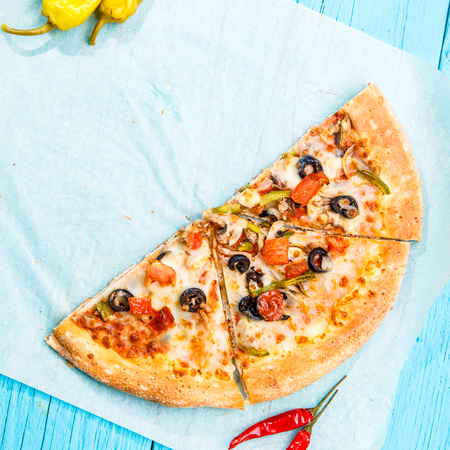 Vegetarian pizza with vegetables on blue table.の写真素材