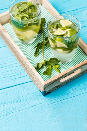 Two glasses of mojito in wooden box with mintの写真素材