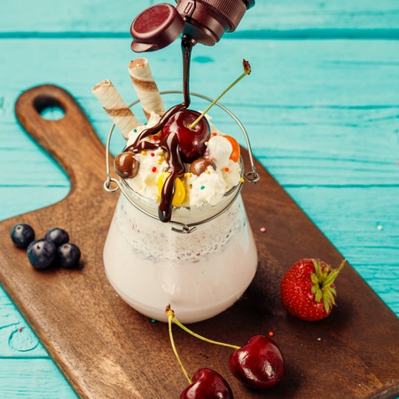 Fresh cherry milkshake and berries sprinkles chocolate.の写真素材