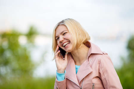 Woman talking on the phone and laughingの写真素材