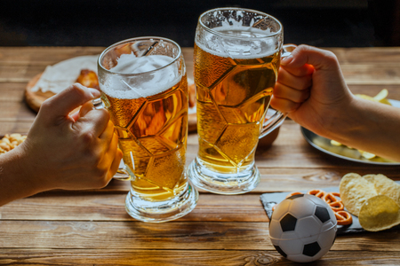 Appetizers and beer on the table for watch the football match.の写真素材
