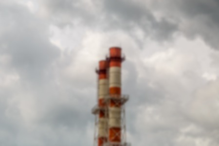 Industrial pipes on gray sky. Blurred urban landscapeの写真素材