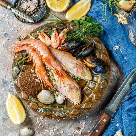 Seafood at table with lemonの写真素材