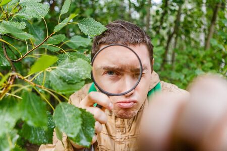 Portrait of man botanist with magnifying glassの写真素材