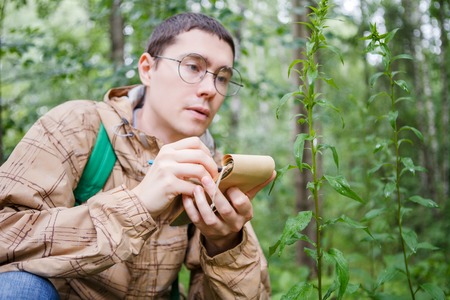 Picture of biologist man in glasses with notebook