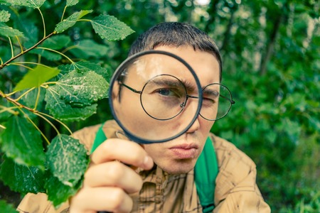 Portrait of male botanist with magnifying glassの写真素材