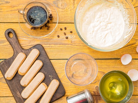 Table with biscuits, cups with cream, egg whiteの写真素材