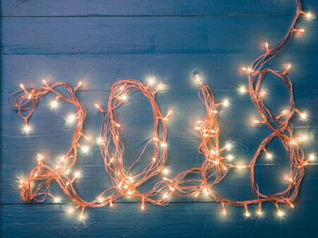 Photo of burning garland in form of number 2018の写真素材