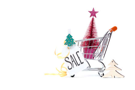 Image of cart with Christmas tree, greeting card, ribbon on empty white background.