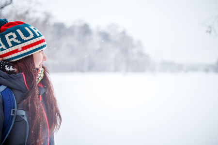Portrait of side view of woman with long hair in winter forestの写真素材