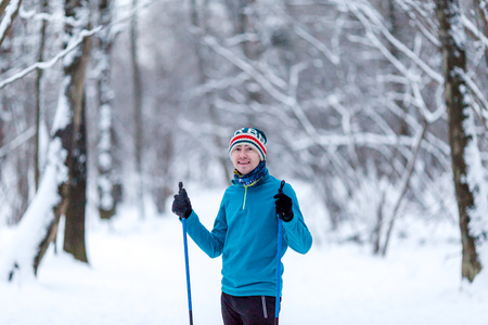 Portrait of male skier in forest at winterの写真素材
