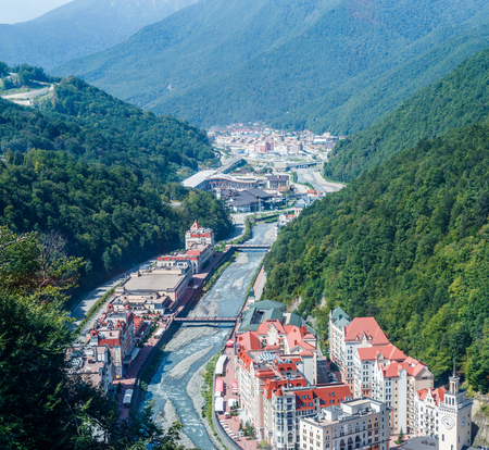 Image of buildings, rivers at foot of mountainsの写真素材