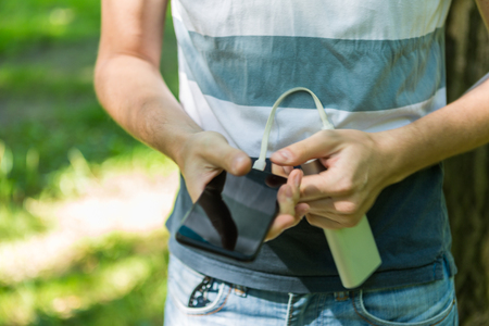 Photo of man holding phone and powerbank