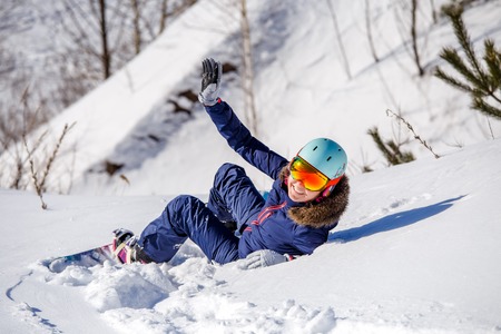 Image from back of athlete in helmet lying on snowy slope