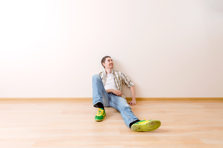 Photo of man sitting on floorの写真素材