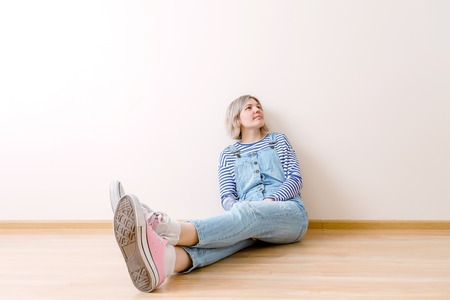 Photo of young woman sitting on floorの写真素材