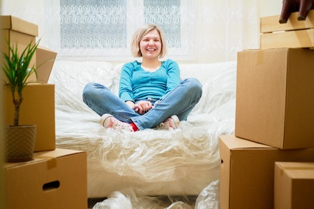 Picture of young blonde sitting on couchの写真素材