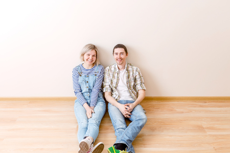 Photo of man and woman sitting on floorの写真素材