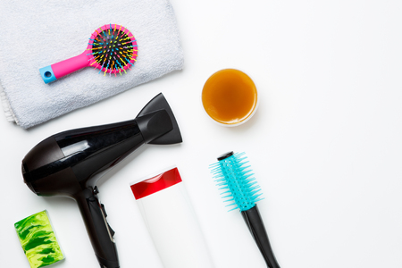 Photo of hair dryer, comb, scissors, towels, soaps isolated on white background.の写真素材