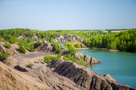 Photo of picturesque hilly area with vegetation and blue lakeの写真素材