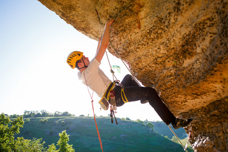 Image of tourist man in helmet clambering upの写真素材